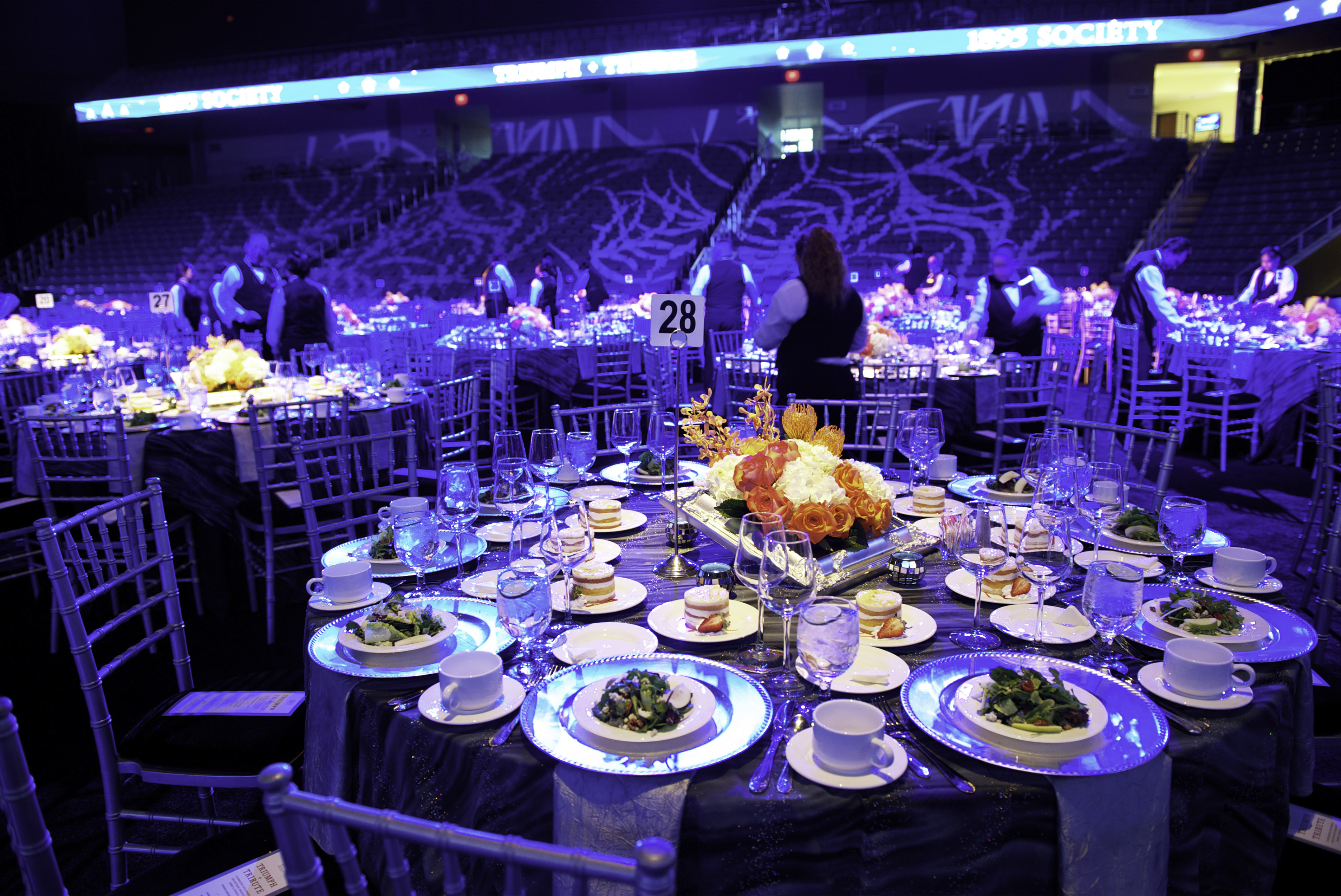 A banquet set up on the College Park Center arena floor. Low lighting